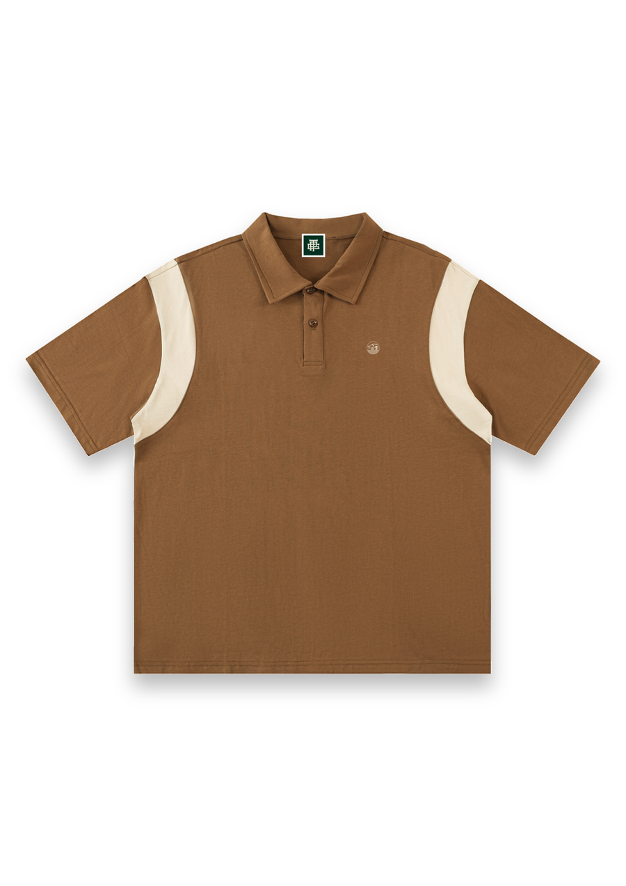 Dogleg cotton golf polo shirt in Brown with Cream, front view with cream shoulder panels and the round Three Putt cow badge on the chest #Colour_Brown with Cream
