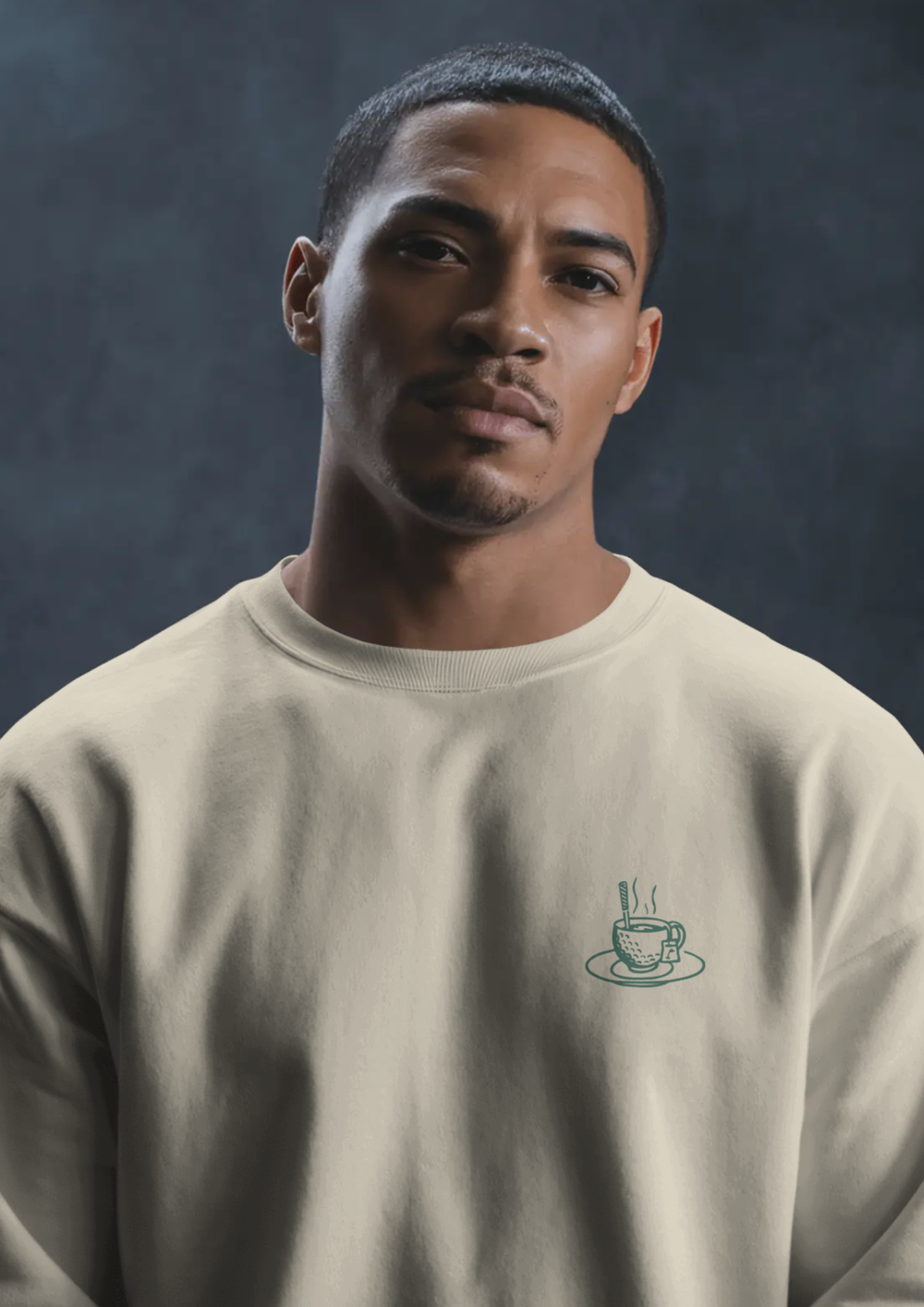 Man wearing the Tee Time golf sweatshirt in Cream, with the teacup print on the chest