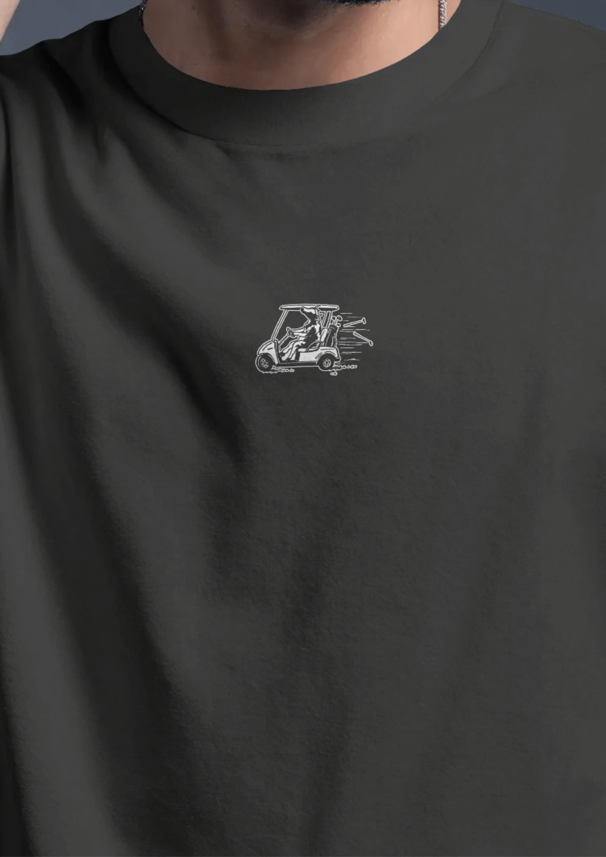 Close-up of the cow-and-golf-cart print on the chest of the Reckless Driving golf T-shirt in Black