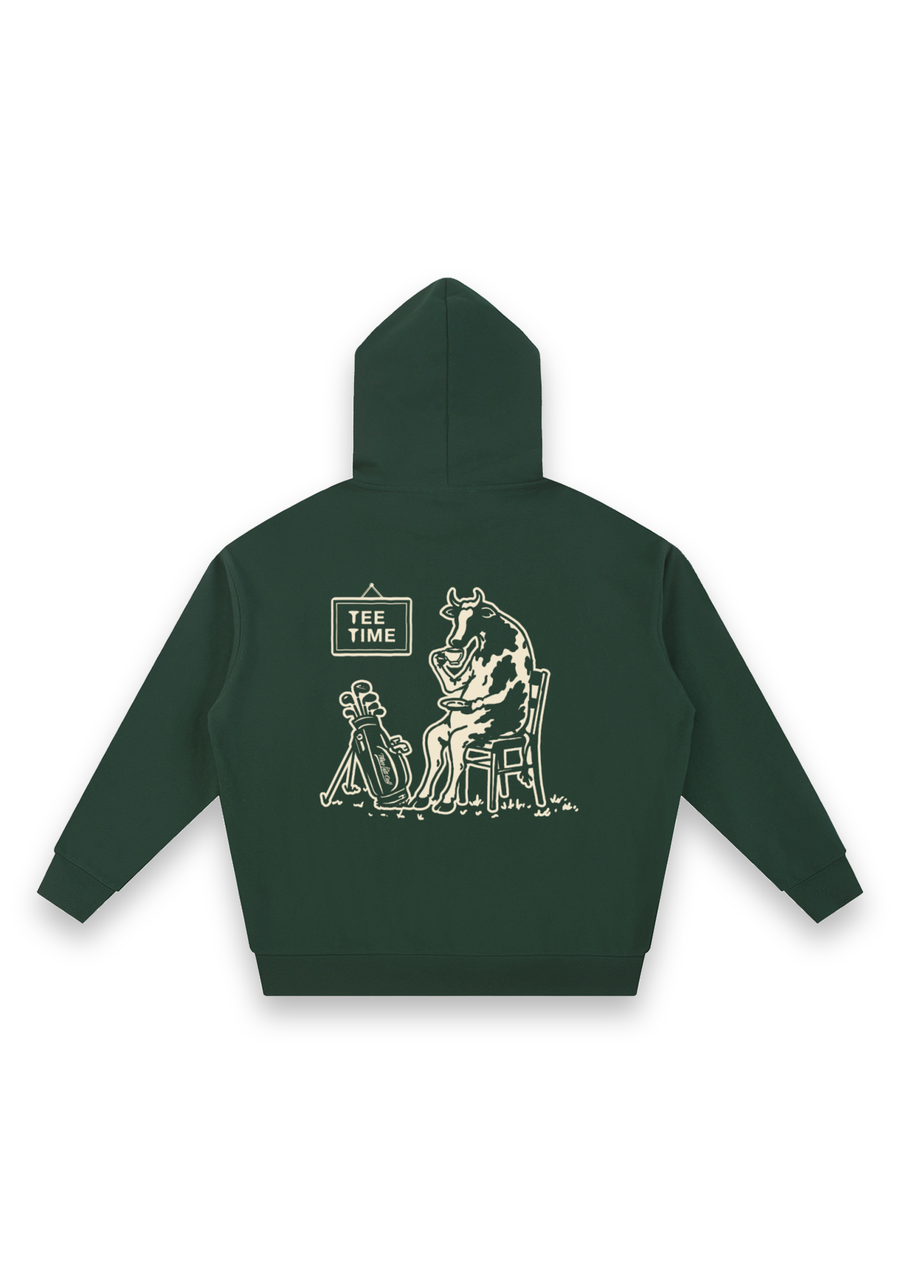 Tee Time golf hoodie in Forest Green, back view showing the cow having a cup of tea beside its clubs under the Tee Time sign